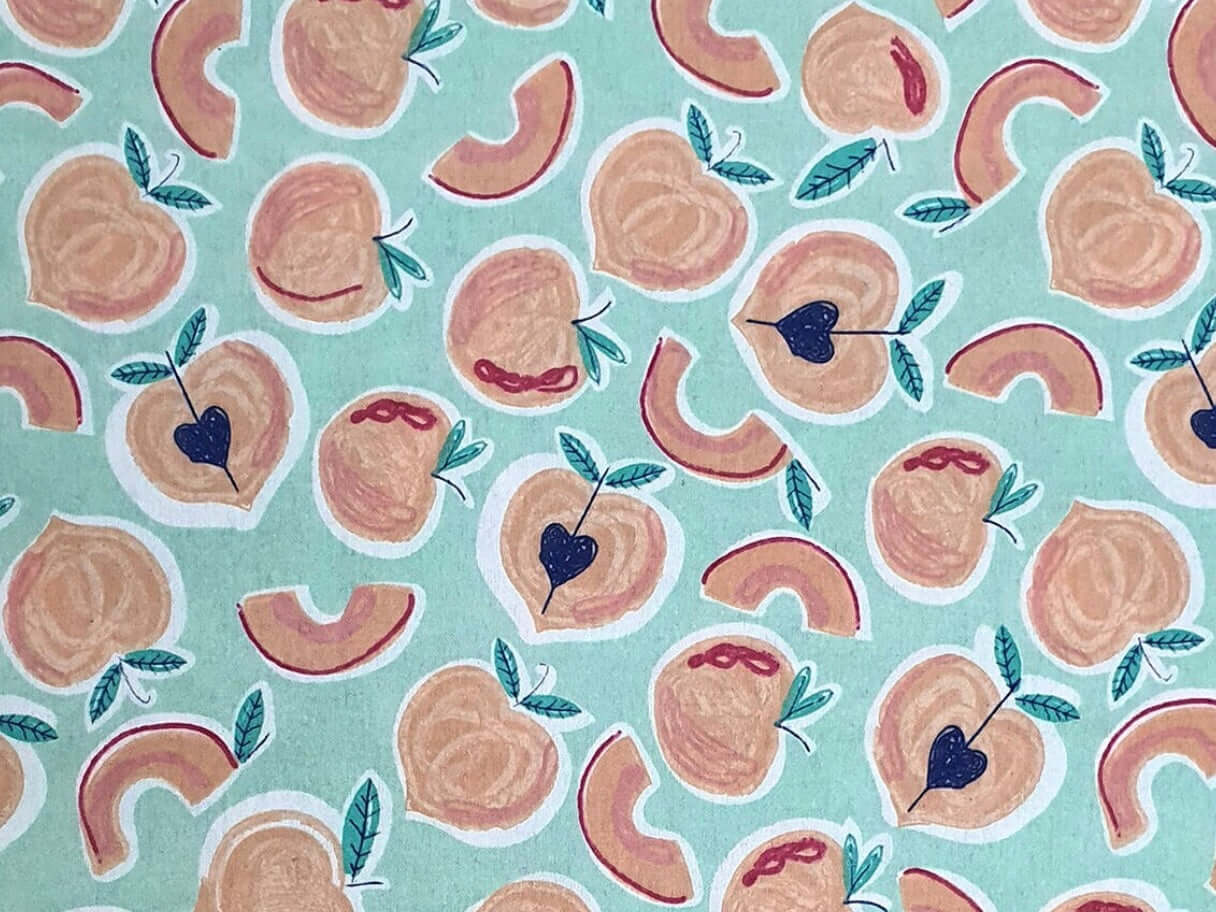 Rice heating pad made with soft cotton flannel with peaches printed all over it - teal background