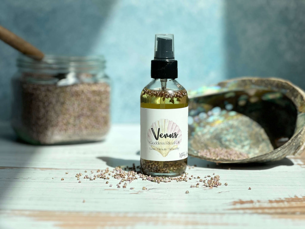 Bottle of 'Venus' product on a wooden surface with jars and shell in the background