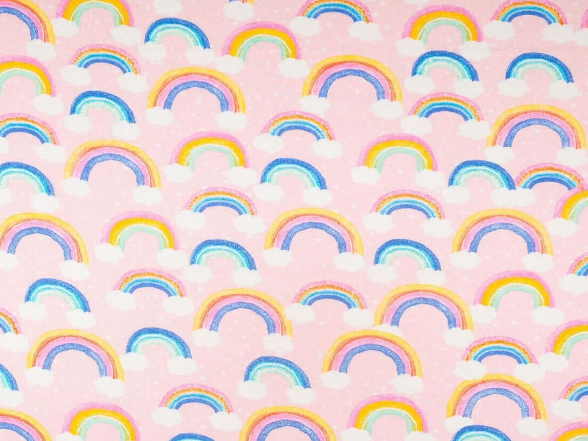 Rice heating pad made with soft cotton flannel with rainbows printed and a pink background