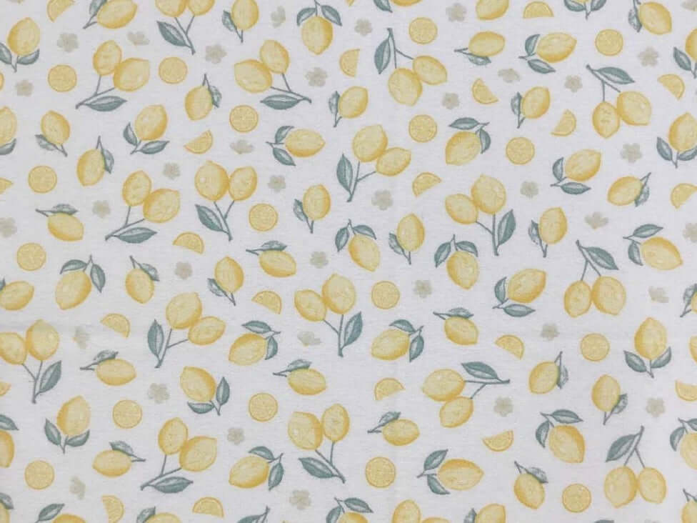 Rice heating pad made with soft cotton flannel with soft yellow lemons printed all over it- cream background