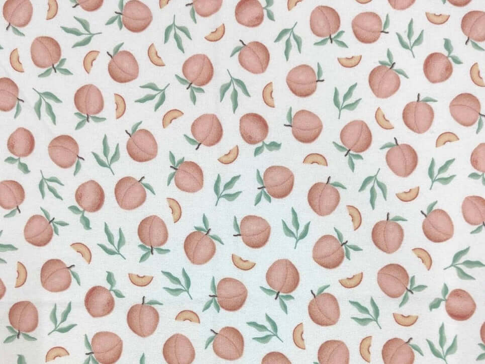 Rice heating pad made with soft cotton flannel with peaches printed all over it - cream background