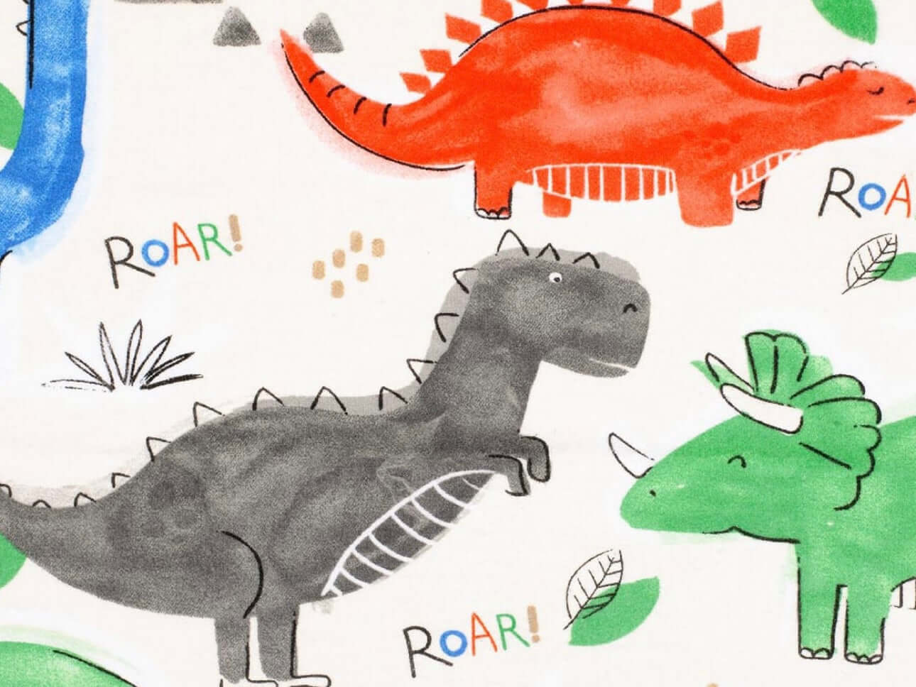 Rice heating pad made with soft cotton flannel with green, red, black, and blue dinosaurs printed on it