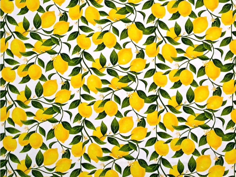 Rice heating pad made with soft cotton flannel with bright lemons printed all over it - some cream background showing