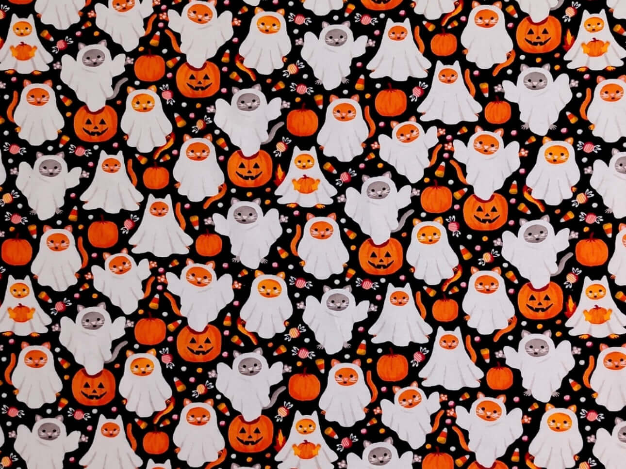 Rice heating pad made with soft cotton flannel with orange and gray cats dressed as ghosts for Halloween printed all over it - black background