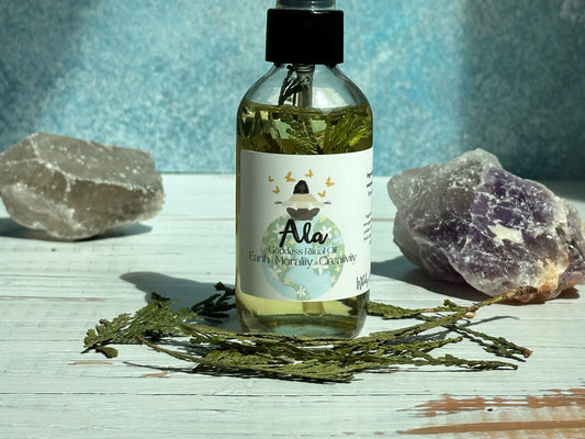 Ala Goddess Ritual Oil in a bottle surrounded by crystals and herbs, designed for self-care and connection to inner power.