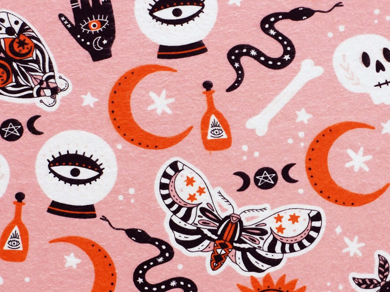 Rice heating pad made with soft cotton flannel with moths, skulls, snakes, and crystal balls printed all over it - pink background