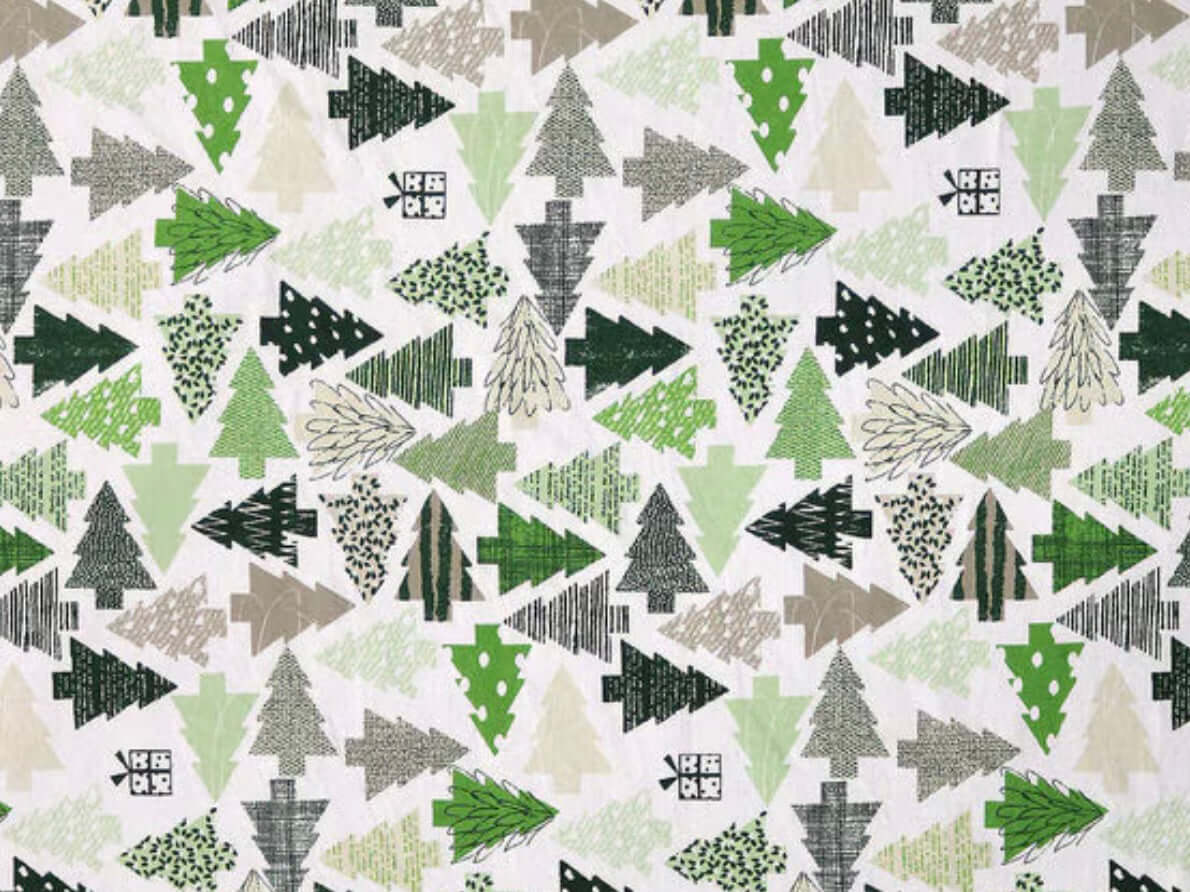 Rice heating pad made with soft cotton flannel with trees in different shades of green printed all over it - cream background