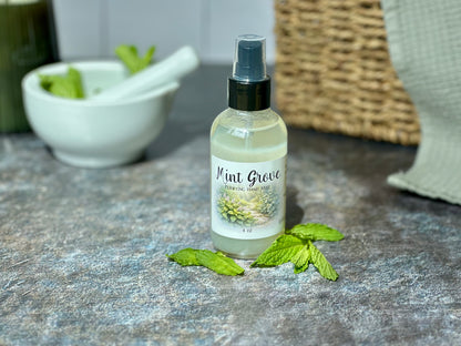 Mint Grove Purifying Hand Mist bottle with fresh mint leaves and a bowl in the background.