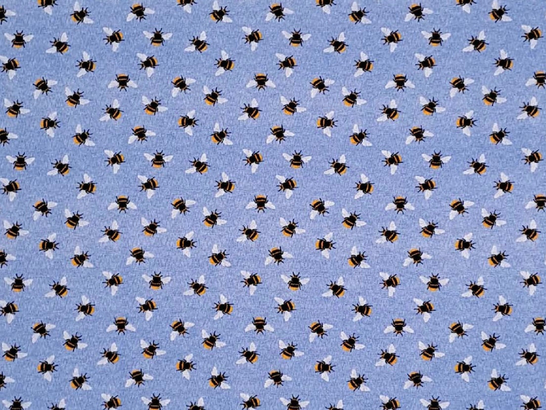 Herbal Comfort Heat Pack - Spring Patterns fabric featuring a blue background with a pattern of bees and flowers.