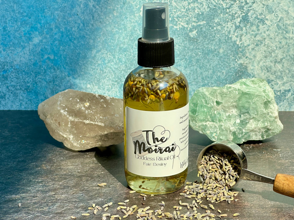 Bottle of 'The Moirai' oil with lavender on a stone surface