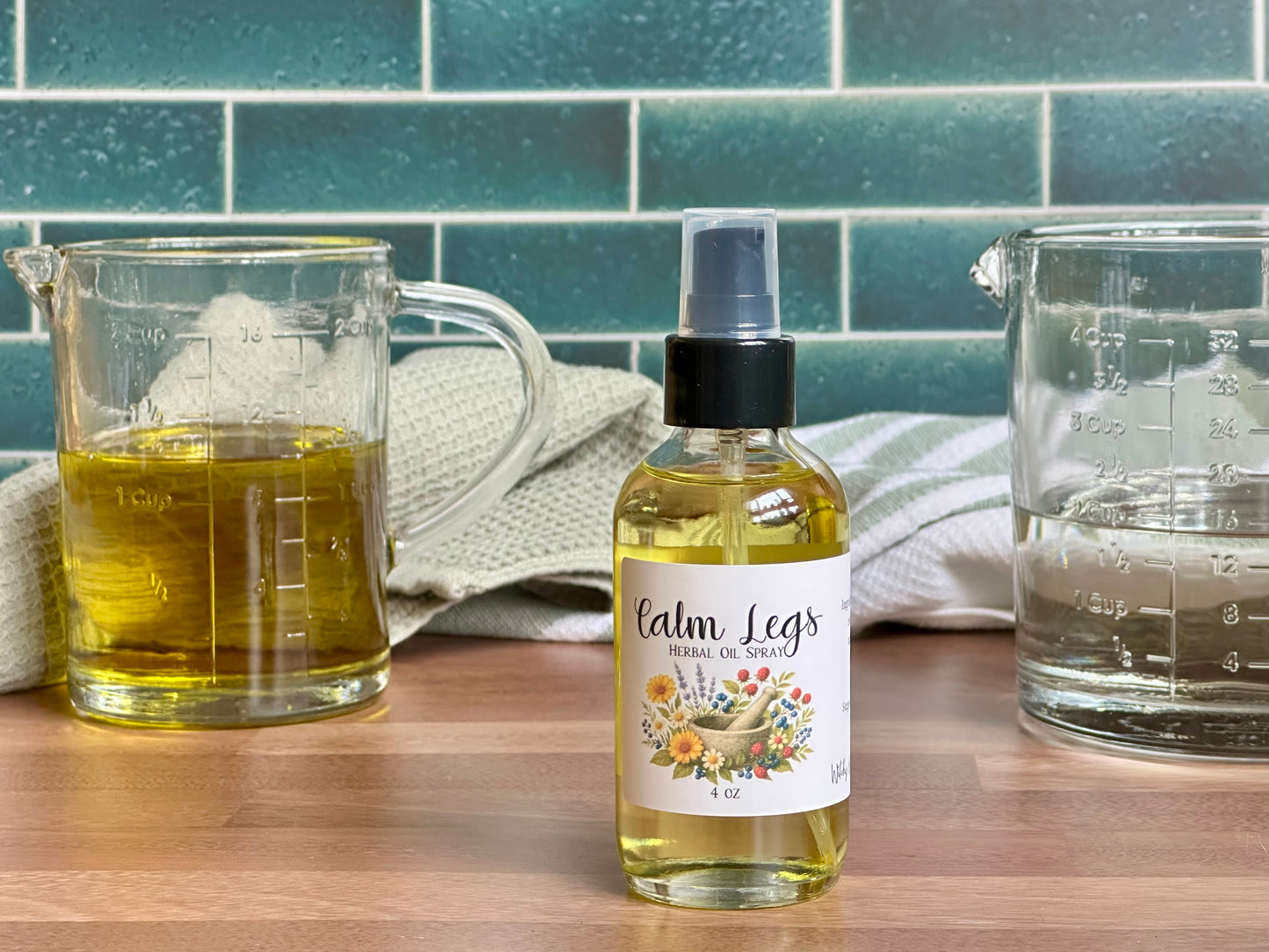 Bottle of 'Calm Legs' herbal spray on a wooden surface with measuring cups and a towel in the background.