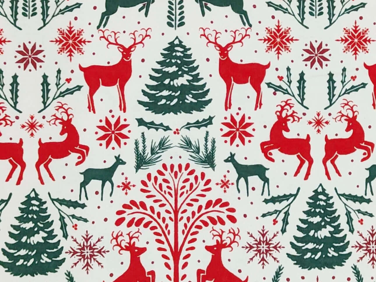 Rice heating pad made with soft cotton flannel with trees and deer printed all over it in red and green - cream background