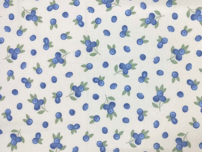 Rice heating pad made with soft cotton flannel with blueberries printed all over it -cream background