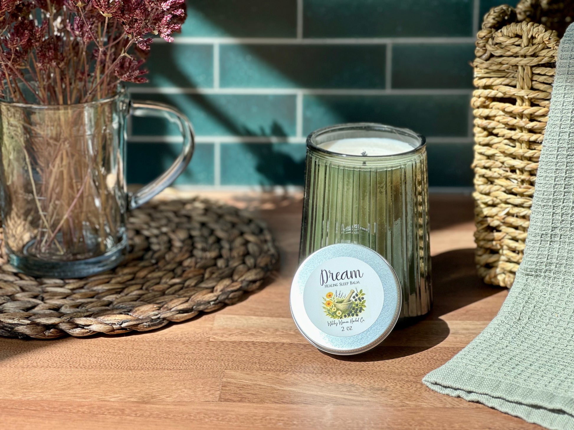 Dream Healing Sleep Balm beside a calming candle and dried flowers on a wooden table, perfect for bedtime rituals.