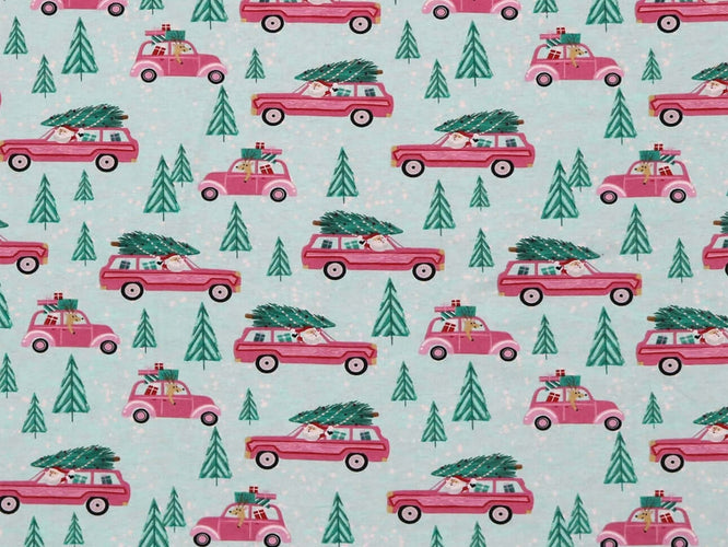 Rice heating pad made with soft cotton flannel with pink station wagons and Christmas trees printed all over it - teal background