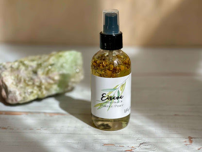 Eirene Goddess Ritual Oil bottle on a wooden surface with natural crystals, promoting peace and self-care.