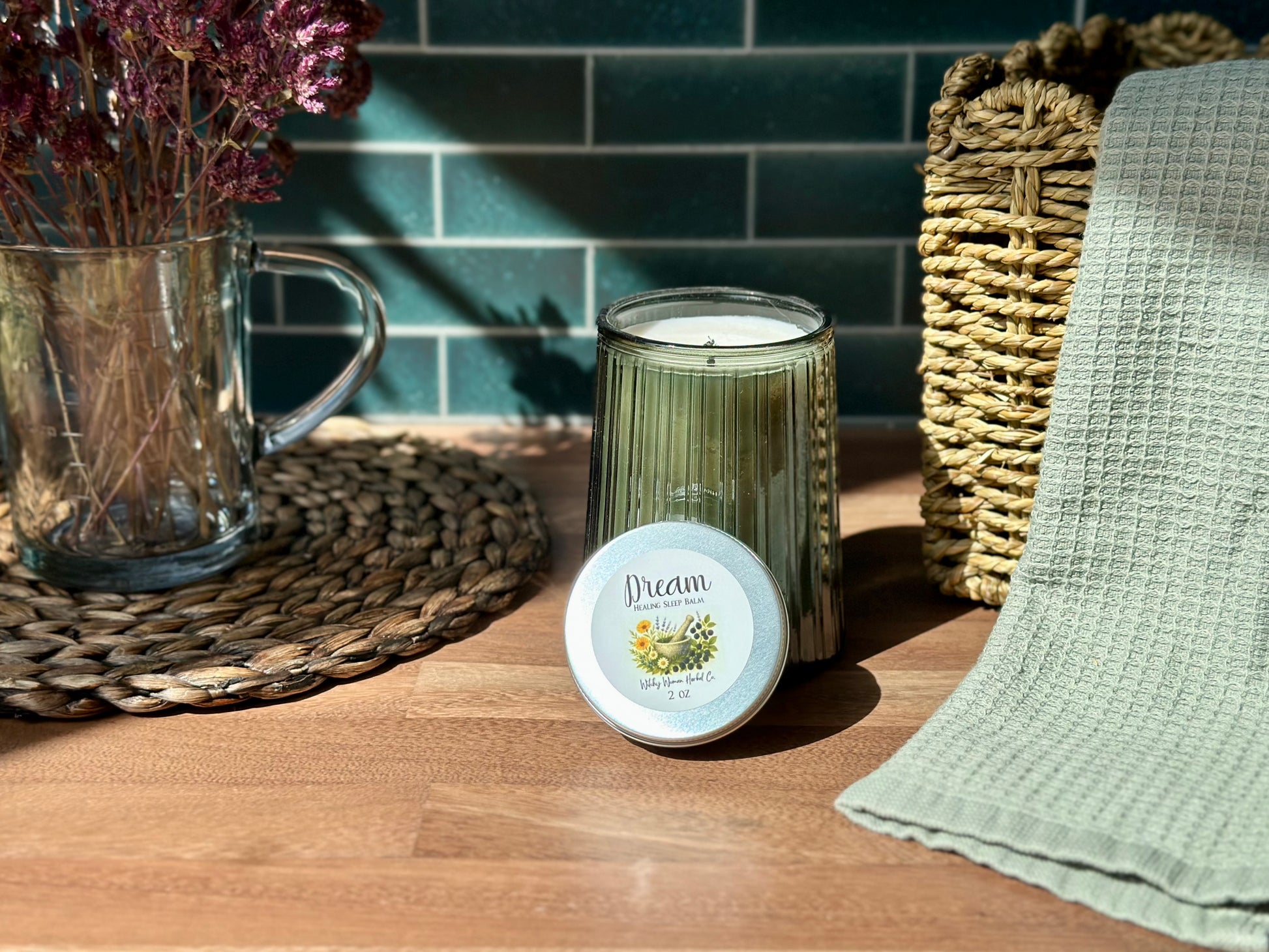 Dream Healing Sleep Balm beside a calming candle and dried flowers on a wooden table, perfect for bedtime rituals.