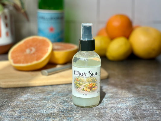 Citrus Sun Purifying Hand Mist bottle with fresh citrus fruits in the background.