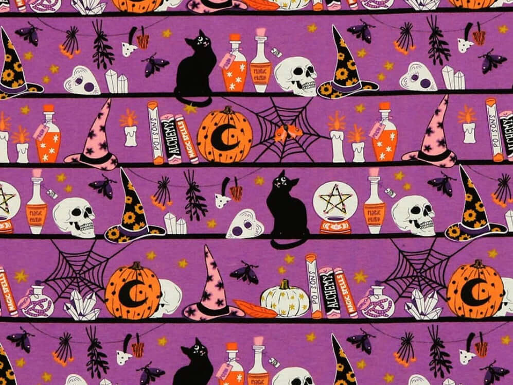 Rice heating pad made with soft cotton flannel with black cats, skulls, witches hats printed all over it - purple background