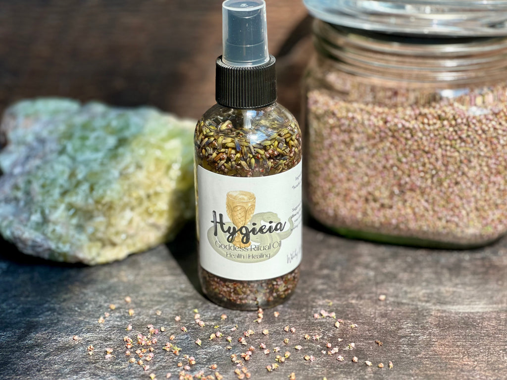 Bottle of Hygieia product with a label on a wooden surface with a jar of dried heather and crystal in the background.