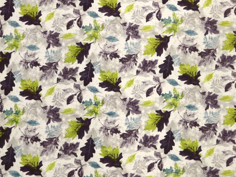Rice heating pad made with soft cotton flannel with purple, green, and blue leaves printed all over it - creamy gray background