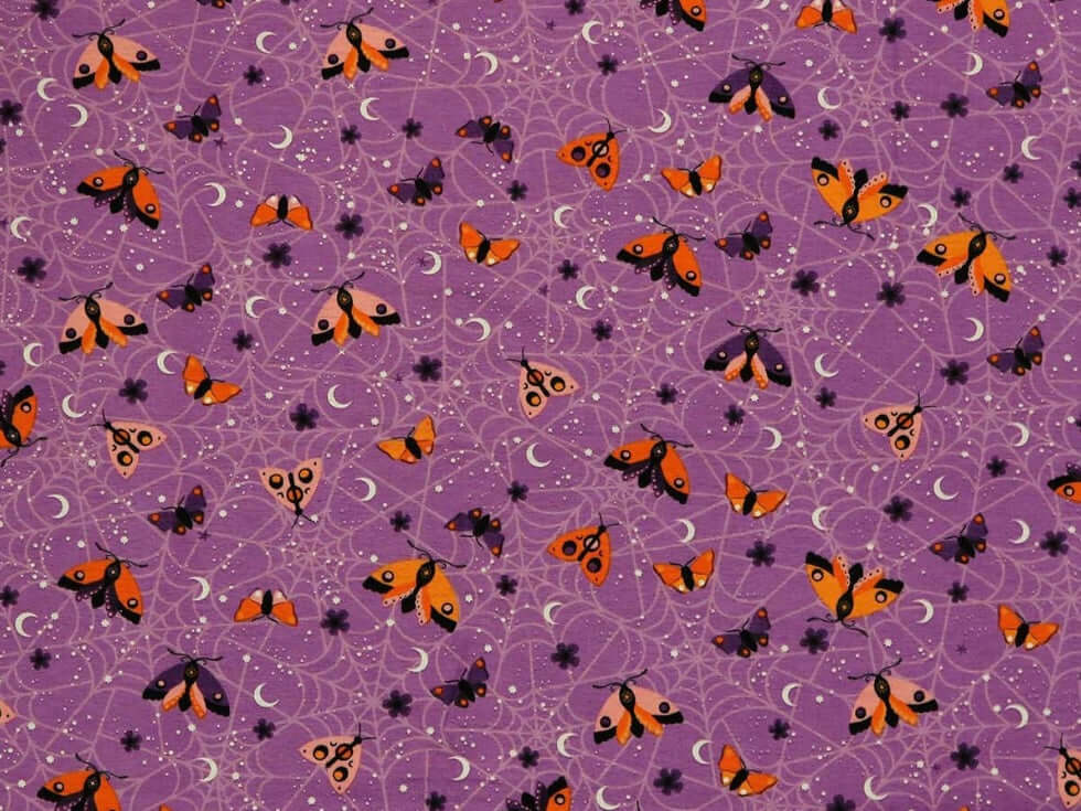 Rice heating pad made with soft cotton flannel with moths and spiderwebs printed all over it - purple background