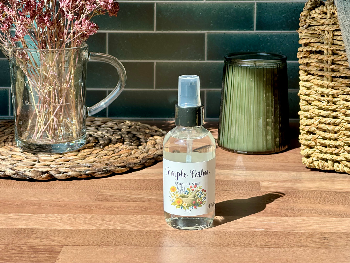 Temple Calm Herbal Oil Spray bottle on a wooden surface with a calming setting and natural light.