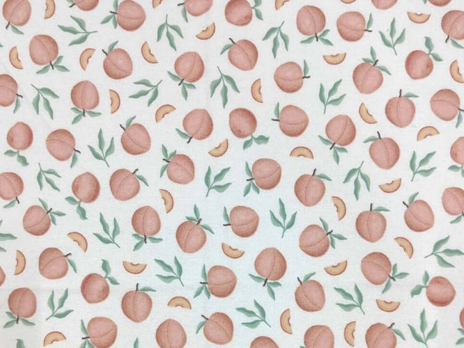 Rice heating pad made with soft cotton flannel with peaches printed all over it - cream background
