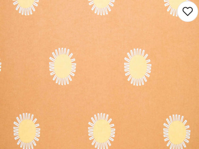 Rice heating pad made with soft cotton flannel with suns printed all over it - orange background