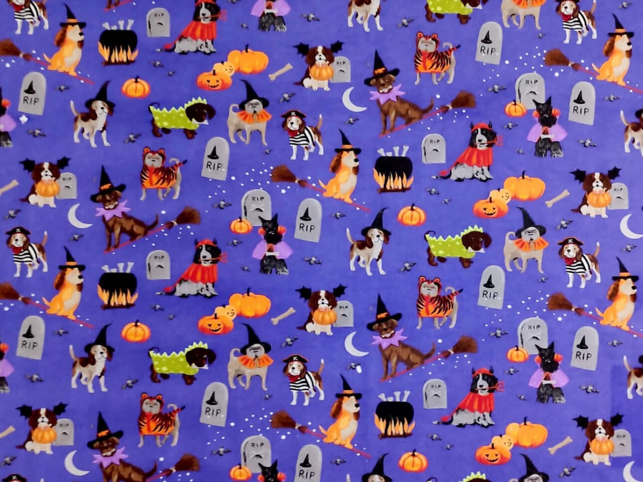 Rice heating pad made with soft cotton flannel with different dogs dressed in costume for Halloween printed all over it - purple background