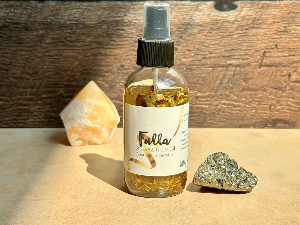 Bottle of Fulla oil with a spray nozzle on a wooden surface with crystals.